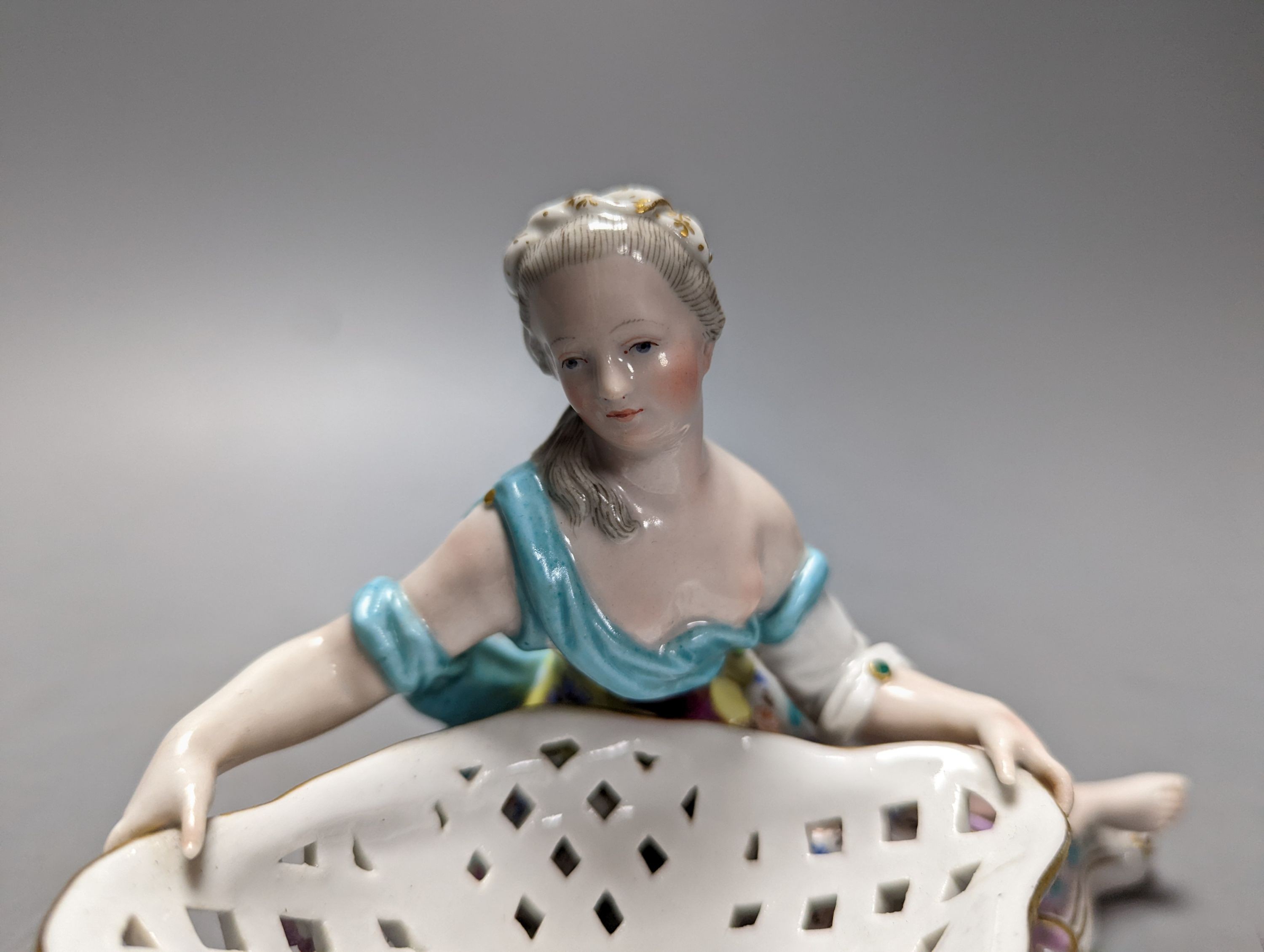 A 19th century Meissen figural basket, incised number to base ‘2875’ 17cm